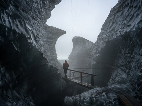 A peson wallking out of Katla Ice Cave, M&yacute;rdalsj&ouml;kull Glacier, South Iceland.