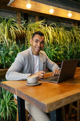 Man working on laptop at cafeteria