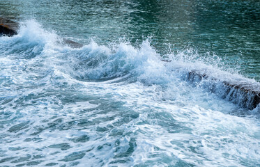 Frothy Ocean Waves Breaking in Waikiki with Sunlight.