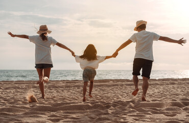 Happy asian family enjoy the sea beach. father, mother and daughter having fun playing beach in summer vacation on the ocean beach. Happy family with vacation time lifestyle concept.