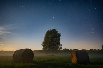 hay bales in the field under the stars
