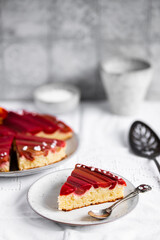Rhubarb cake with geometric pattern on a white stone background. Spring and summer sweet-sour healthy dessert. Close-up view