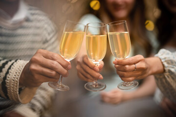Group of friends celebrating with champagne  Close up on hands.