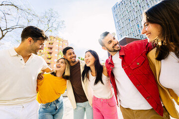 Diverse group of young people having fun together outdoors. Multiracial happy friends enjoying summer vacation together. Holidays and friendship concept.