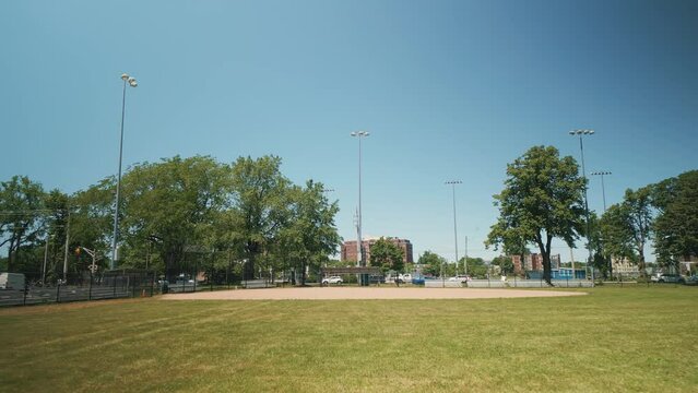 Aerial View Softball and Baseball Field in Downtown Halifax, Canada Filmed with a Cinematic Drone During the Daytime with Green Grass and Trees on a Summer Day.