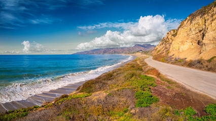Malibu Coastline Seascape with white clouds gathering over the hill and waves rolling in on the...