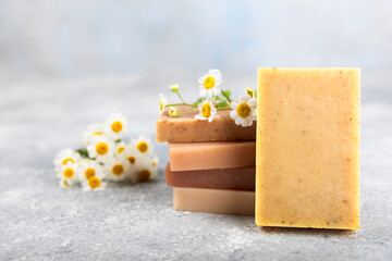 Natural homemade soap with chamomile flowers on a marble background. Spa procedure. Beauty concept. Body skin care. Place for text. copy space.