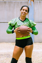 Portrait of mexican woman american football player wearing uniform with velociraptor skin patterns