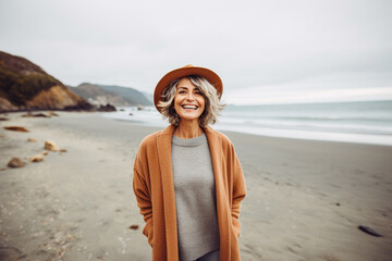 Mature woman in autumnal beach outdoors portrait