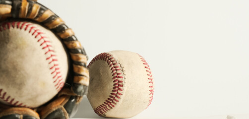 Baseball sports banner with old used baseball balls and glove on white background.