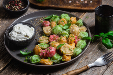 colorful dumplings in a bowl with sauce