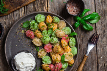 colorful dumplings in a bowl with sauce