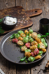 colorful dumplings in a bowl with sauce