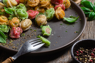 colorful dumplings in a bowl with sauce