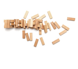 Concept of risk and destruction -A pile of small wooden blocks from a collapsed tower on a white background