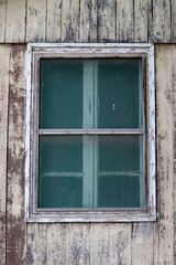 A small window in an old one-story house.