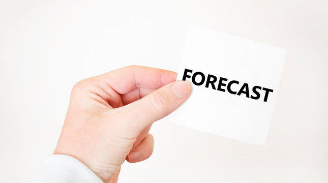 Businessman holding a card with text FORECAST business concept