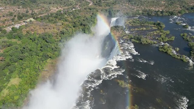 Aerial drone view of Victoria Falls and its rainbows, in between Zambia and Zimbabwe