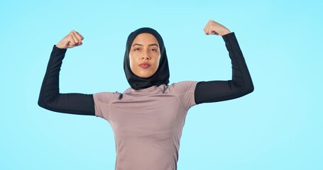 Face, exercise and Islamic woman with fitness, flexing arms and wellness against a blue studio background. Portrait, female person or Muslim model flex, strong and power with energy and workout goals