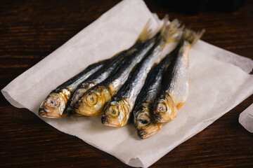 Snack for beer dried fish on a dark wooden background