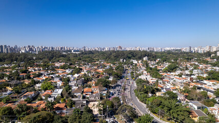 Fototapeta premium Residential buildings and houses in the Itaim Bibi neighborhood in São Paulo, Brazil. Aerial view of Ibirapuera Park with buildings in the background.