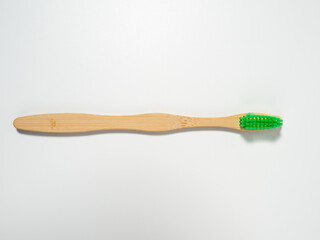 Bamboo toothbrush. Wooden toothbrush on a white background. Toothbrush close-up.