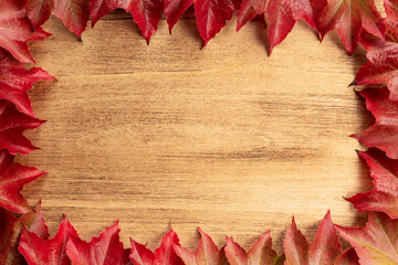 Thanksgiving background with autumn leaves on wooden old background with copy space, top view