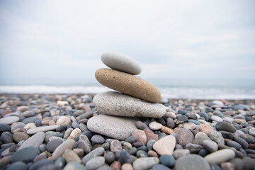 Obraz na płótnie Canvas Pebbles on the seashore, large and small stones on the sea.