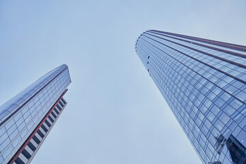 A view from below of modern skyscrapers in the business district against the blue sky. I'm looking...