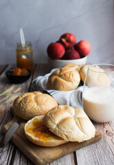 Buns with apricot jam. On a wooden table. Breakfast