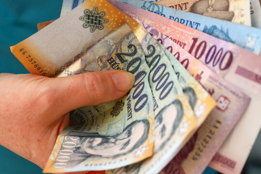 Hungarian forint money, Woman clutching a handful of banknotes, Large denominations, Inflation and financial situation in Hungary