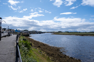 Obraz premium Looking Along Irvine Harbour North Ayrshire Scotland on a bright day in April with Arran in the Hazy Distance