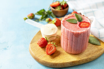 Obraz na płótnie Canvas Fresh milk, strawberry drinks on wooden board on a stone background, protein shake with fresh berries. Copy space.
