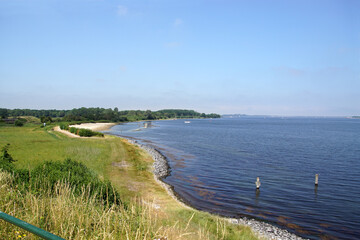 Fototapeta na wymiar View of the sandy beach called Bastionstrand (Bastion beach) at the Zeeland lake called Veerse Meer. Near the city of Veere. Grass, Nature. Netherlands, Summer, June