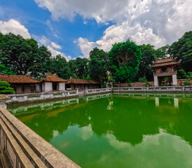 Fototapeta premium Literature Temple surrounded by beautiful gardens old historic buildings Bonsai plants and old trees in Hanoi Vietnam 
