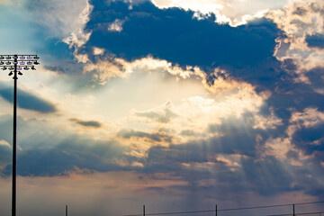 sun rays peaking around clouds