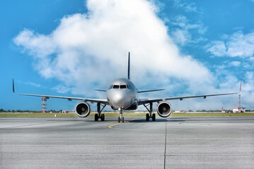 A big silver jet ready to take off at the airport.