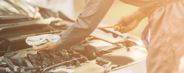Auto mechanic checking and maintenance to customer the engine a vehicle car hood and masters inspector replaces the damaged parts in car while checking the work of the car. Service, repair concept