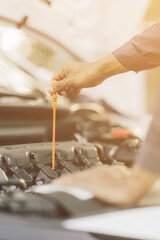 Auto mechanic checking and maintenance to customer the engine a vehicle car hood and masters inspector replaces the damaged parts in car while checking the work of the car. Service, repair concept