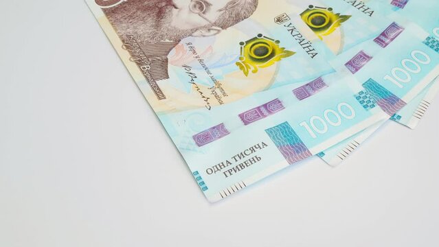 Recalculation of Ukrainian money. Slow motion. Ukrainian money hryvnia laid out. Hands count paper banknotes of 1000 hryvnia. National Bank of Ukraine. Beautiful colorful design. Business concept
