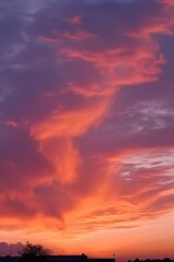 Fototapeta premium a sunrise over a field of clouds and grass, in the style of light orange and dark magenta. AI Generated