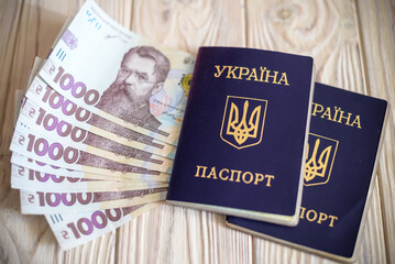 New banknotes in denominations of 1000 hryvnia with a Ukrainian passport. Ukrainian money. Business...