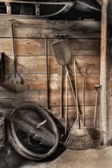 old fashioned farm tools shovels and rakes