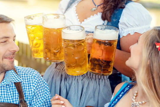Waitress getting lots of beer to patrons of Bavarian pub