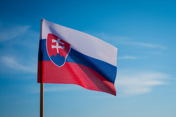 Slovak flag waving in wind and sunlight.