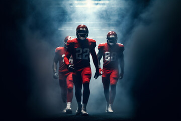 Three football players entering stadium with fog in background.