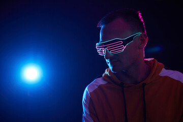 guy in neon cyber glasses on a dark background, cyber space concept