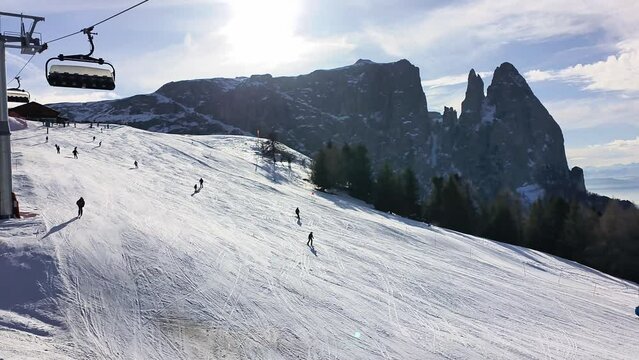 4k video with skiing season footage in the Dolomites mountains in Italy on a beautiful sunny day