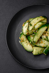 Delicious juicy cucumber cut into large slices with salt, spices and french mustard