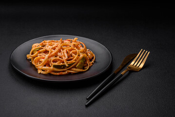 Delicious asian udon dish with vegetables, mushrooms, salt and spices